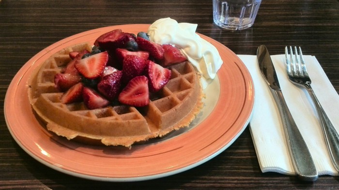 Belgian waffle with strawberries and whip at Marche Restaurant in Toronto
