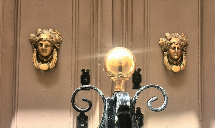 Brass Bacchus face door on brown door, Gozo