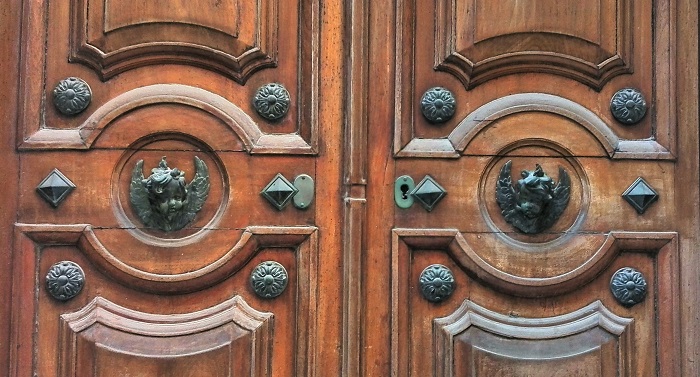 Angel head bronze knocker on wood door with studs, Valletta, Malta