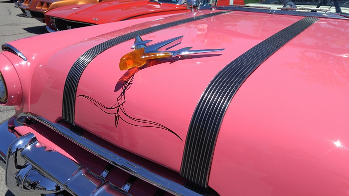 Pink vintage car with orange lucite hood ornament